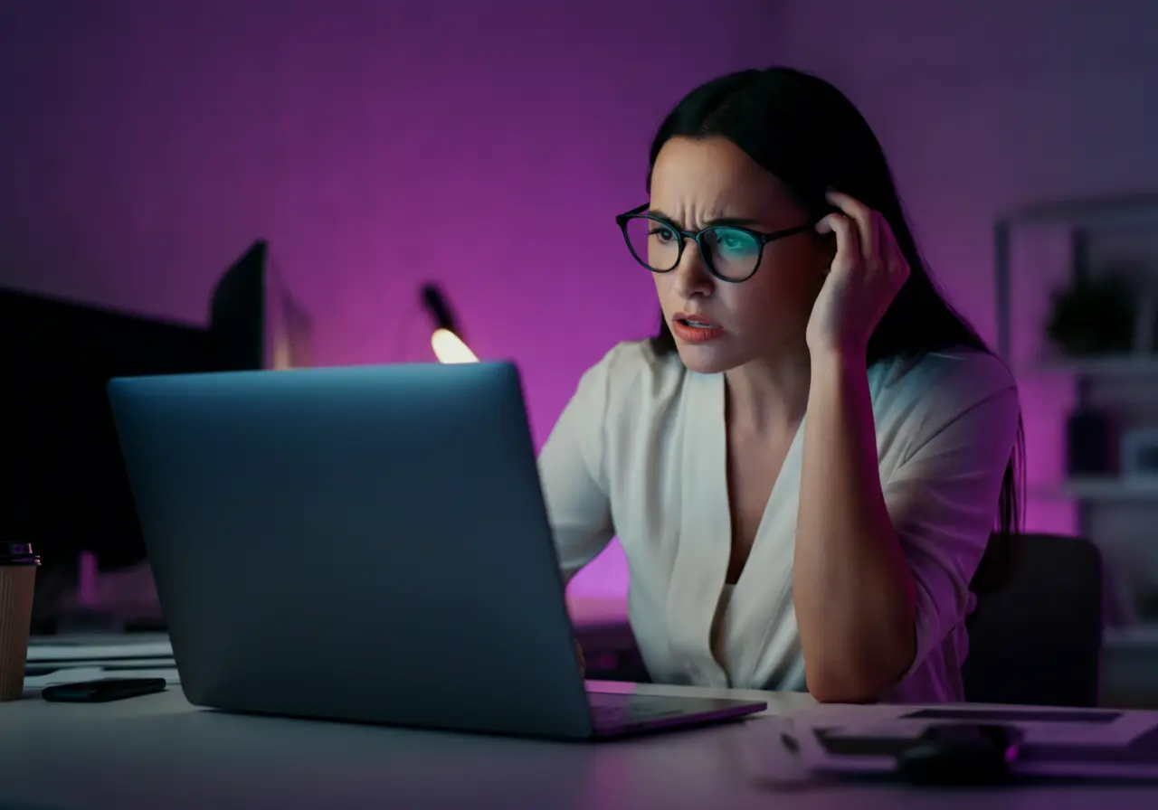 AI generated image by Visual Electric of a female business owner looking at her laptop in a dimly lit office